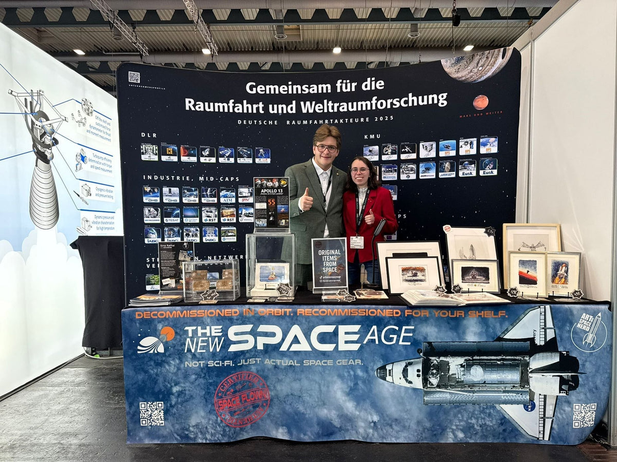 The founders of The New Space Age at their booth at Space Tech Expo Europe 2025 in Bremen