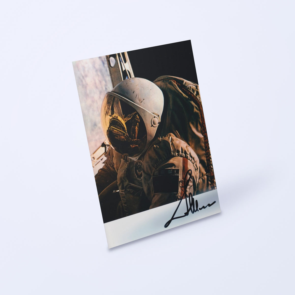 Signed photo of cosmonaut Aleksandr Ivanchenkov in an Orlan spacesuit during a spacewalk, angled view