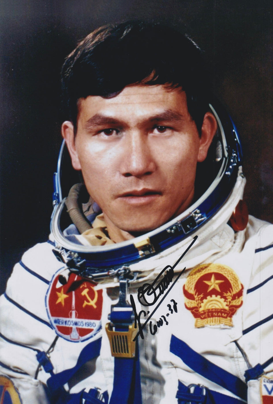 Signed portrait of cosmonaut Pham Tuân in Sokol spacesuit with mission patch, perfect for space memorabilia collectors