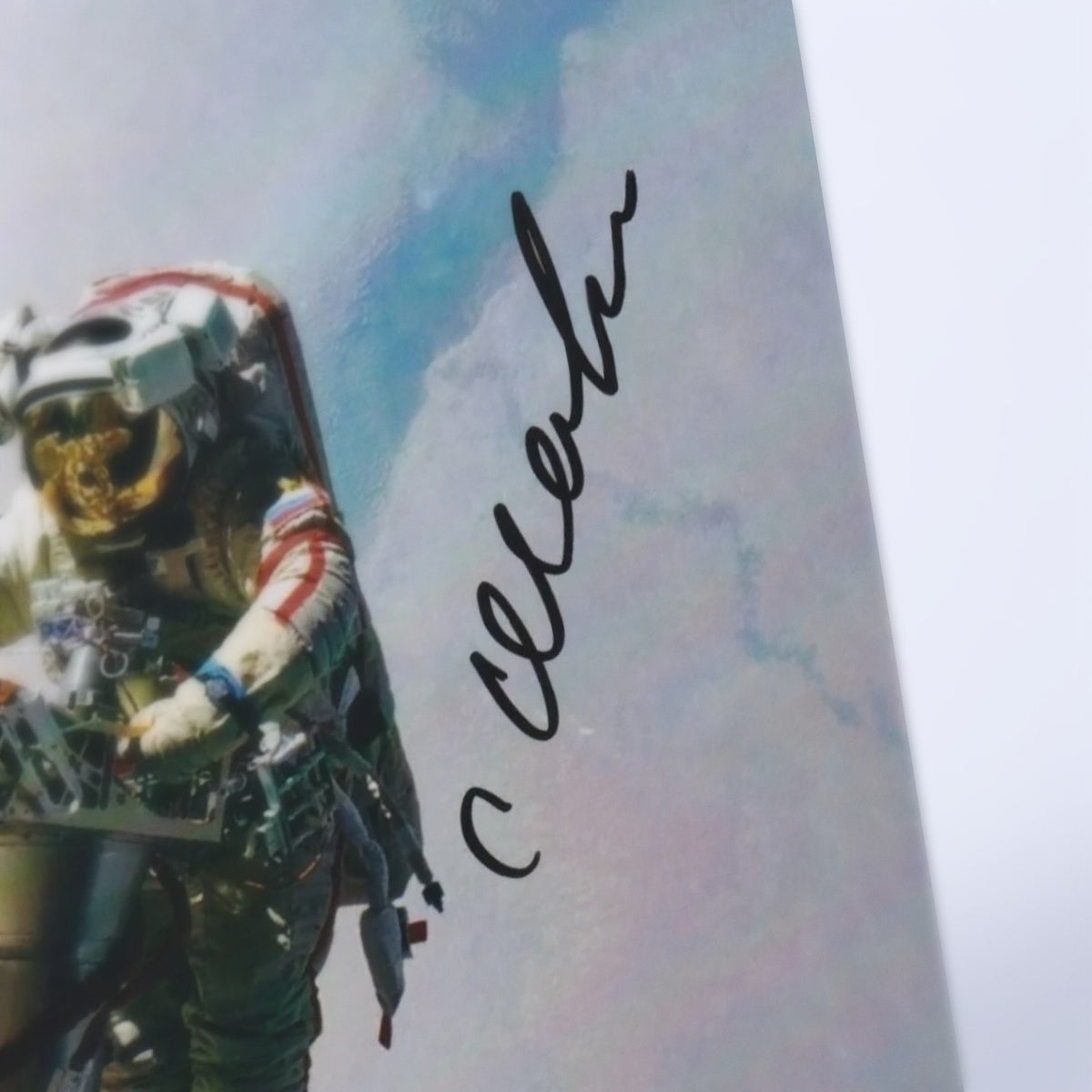 Close-up of Salizhan Sharipov's signature on the photo