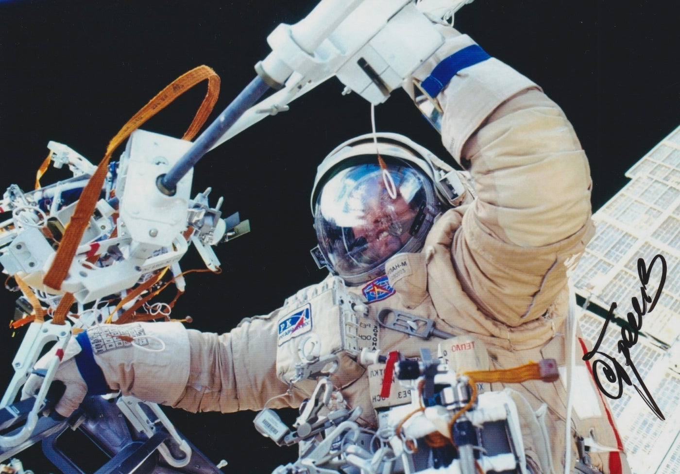 Signed portrait of cosmonaut Sergei Treschev in Orlan EVA spacesuit during spacewalk, perfect for space memorabilia collectors