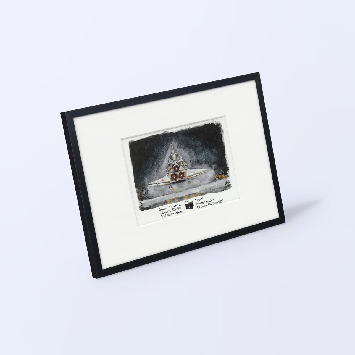 Columbia landing watercolor print, rear view, with a flown STS-94 thermal blanket fragment, black frame, angled view