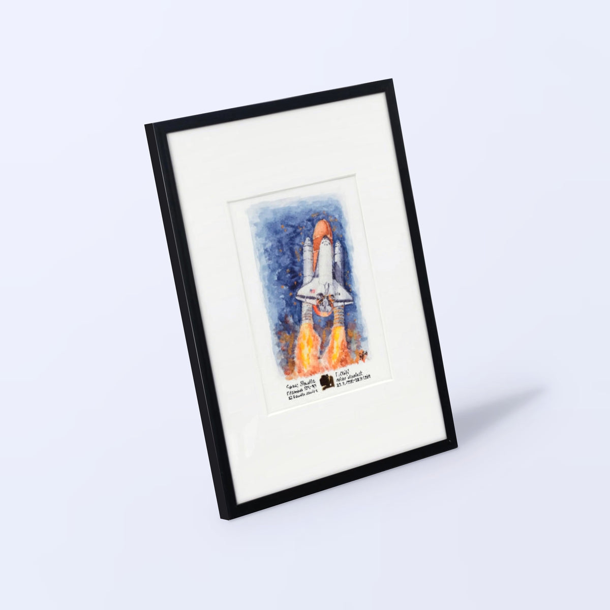 Space Shuttle launch watercolor print with a flown STS-93 solar blanket fragment, black frame, white mat, angled view