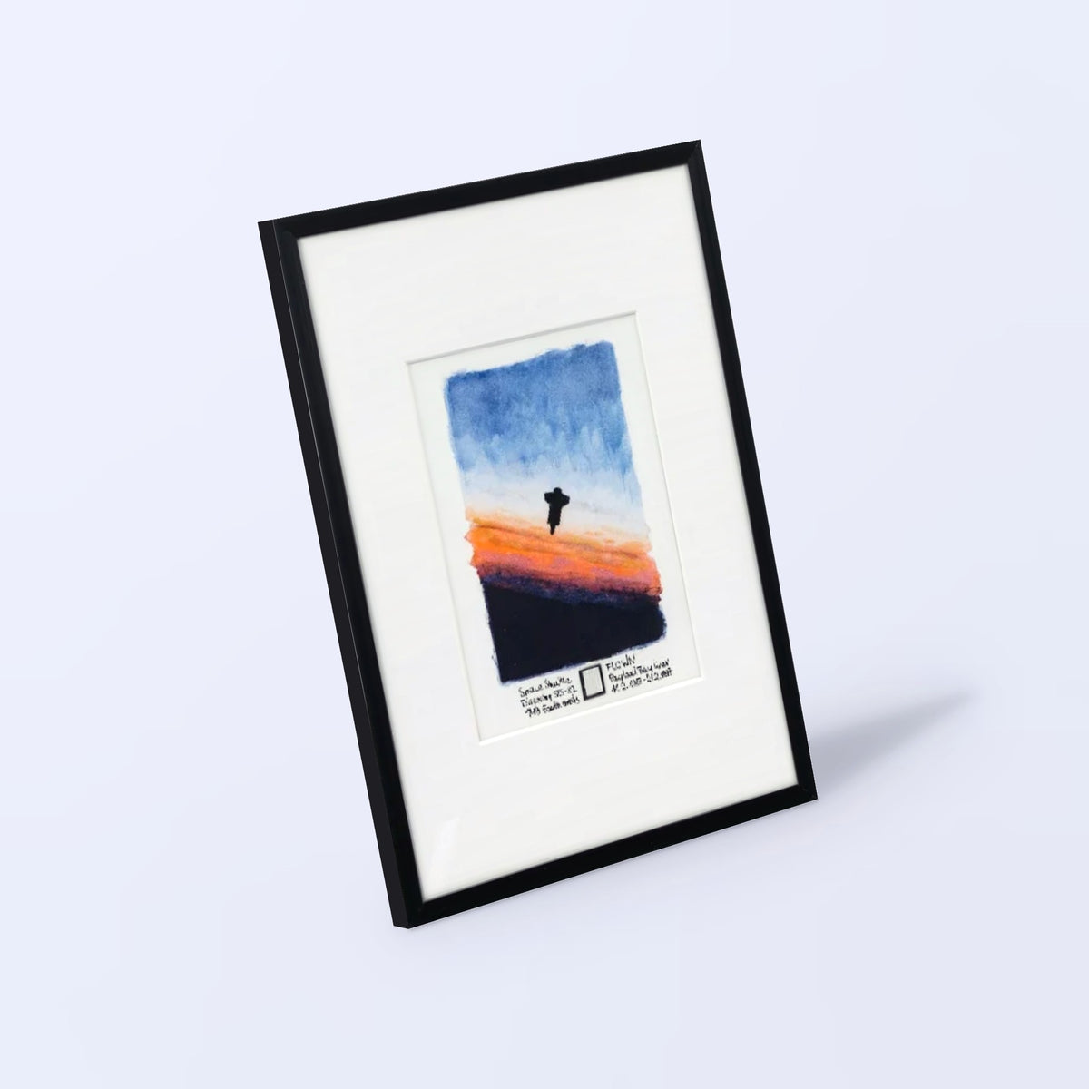 Space Shuttle Sunrise watercolor print with a flown STS-82 payload bay liner fragment, black frame, angled view