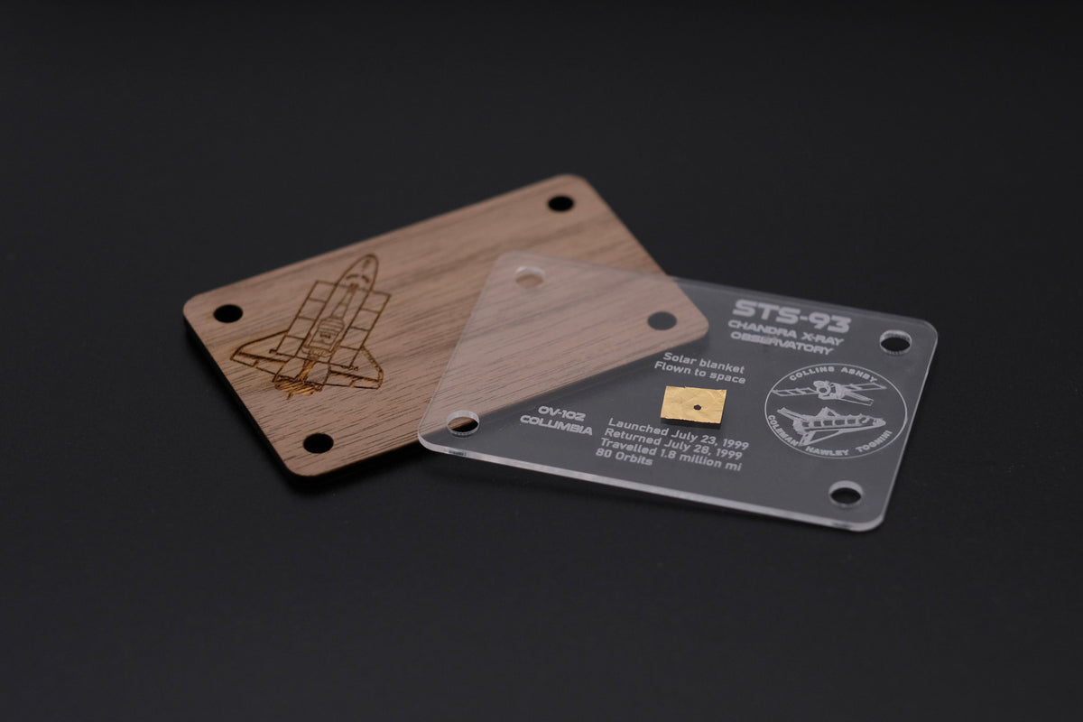 Assembly view of a handcrafted STS-93 artifact card. Shows the laser-cut acrylic front and laser-engraved wooden back with a Space Shuttle Columbia motif, enclosing a piece of flown solar blanket.