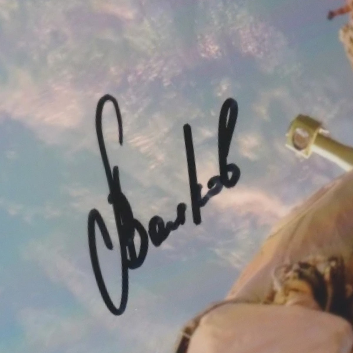 Close-up of Aleksandr Volkov's signature on the photo