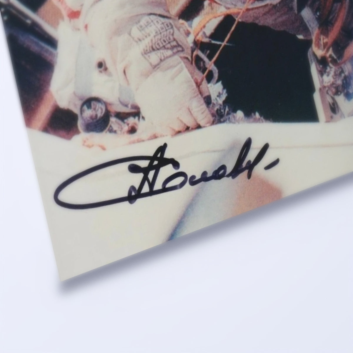 Close-up of Anatoly Solovyev's signature on the Orlan spacesuit portrait
