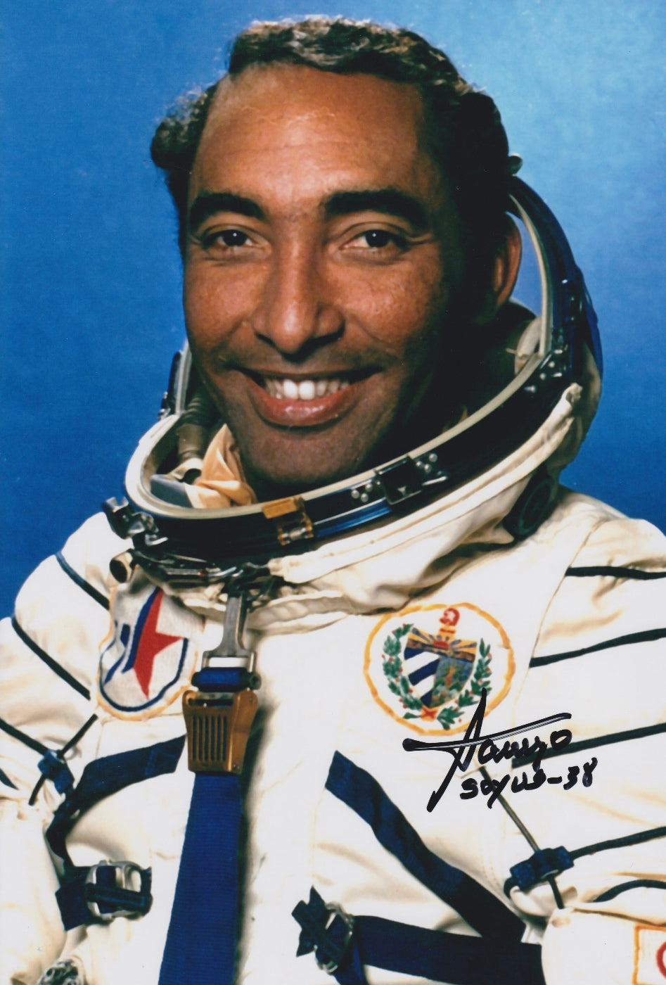 Signed portrait of cosmonaut Arnaldo Tamayo Méndez in Sokol spacesuit with MIR mission patch, ideal for space memorabilia collectors