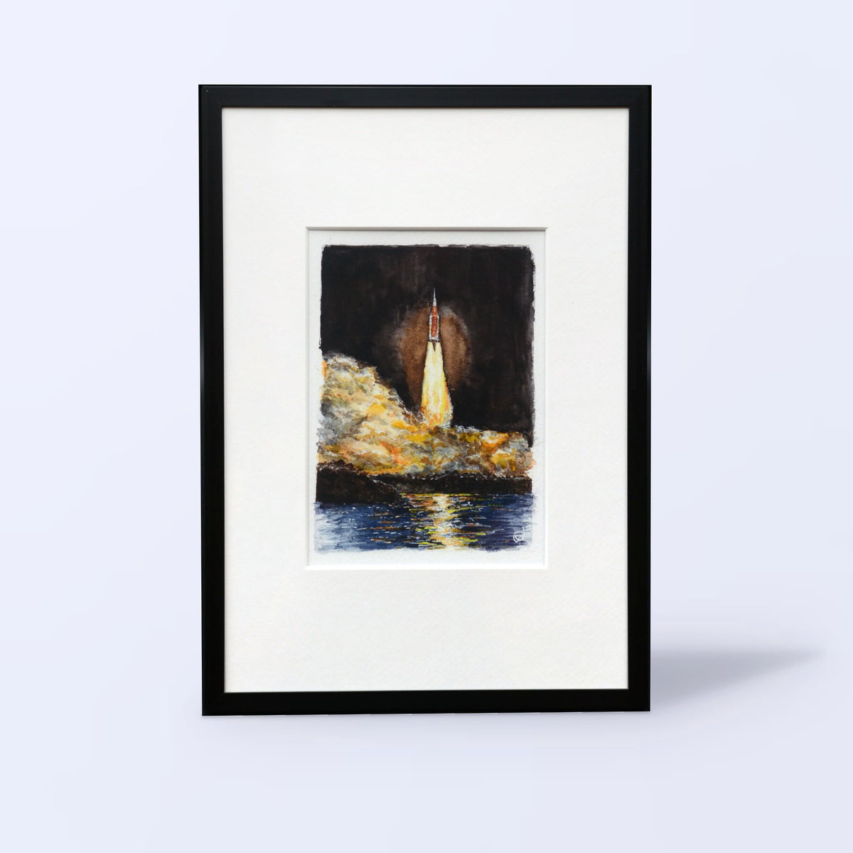 Artemis I watercolor fine art print of the SLS launch in a black frame with white mat, front view