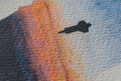 Close-up of the Space Shuttle Sunrise watercolor: the orbiter's silhouette above the orange horizon
