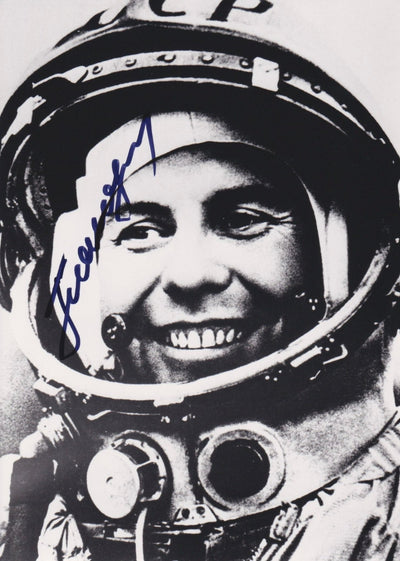 Signed black-and-white portrait of cosmonaut Pavel Popovich in a Vostok-era spacesuit with CCCP helmet
