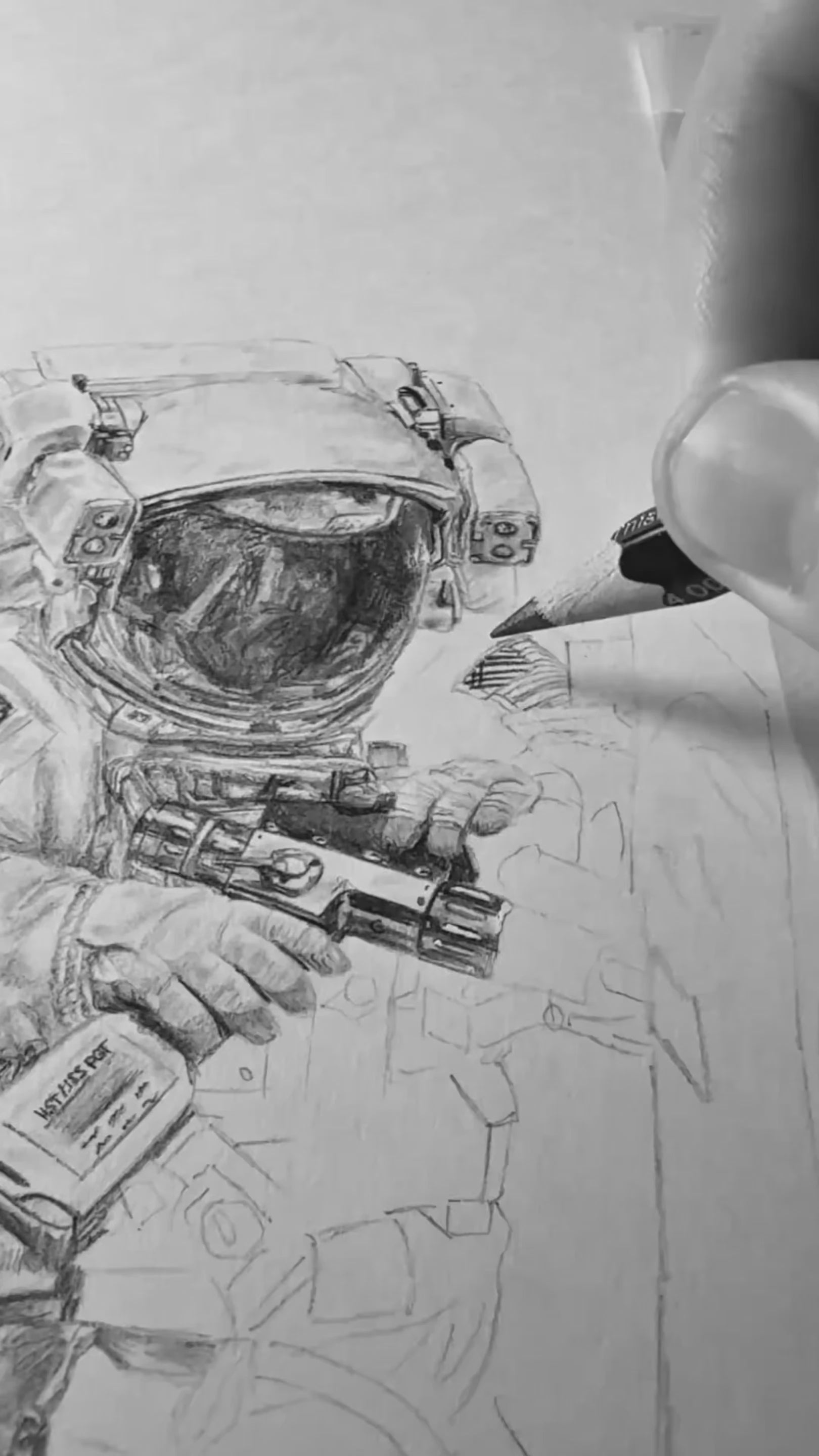 Load video: Video thumbnail showing a close-up of a pencil sketch in progress, with an astronaut suit and helmet being drawn by Art of a Space Nerd.
