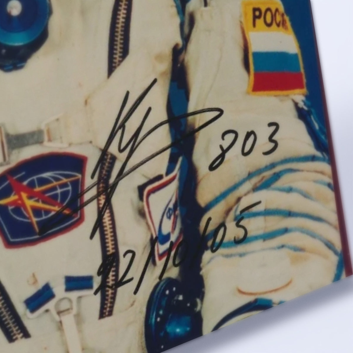 Close-up of Sergei Krikalev's signature and handwritten notes on the photo