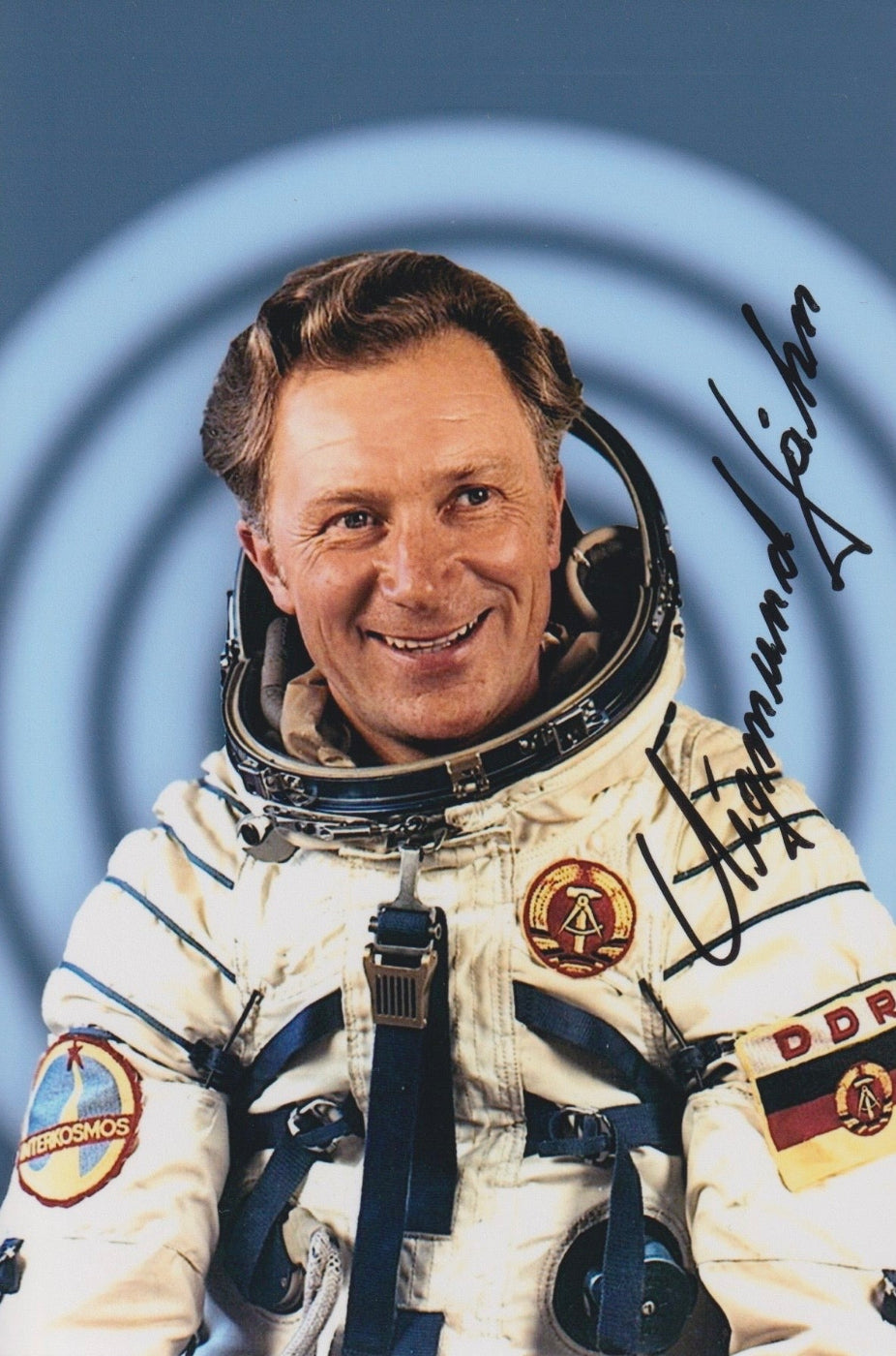 Signed portrait of cosmonaut Sigmund Jähn in Sokol spacesuit with mission patch, perfect for space memorabilia collectors