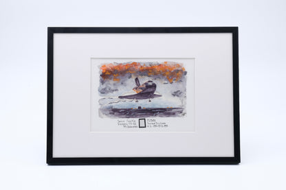 Framed watercolor artwork of Space Shuttle Discovery landing, with a small embedded flown payload bay liner fragment in the print.