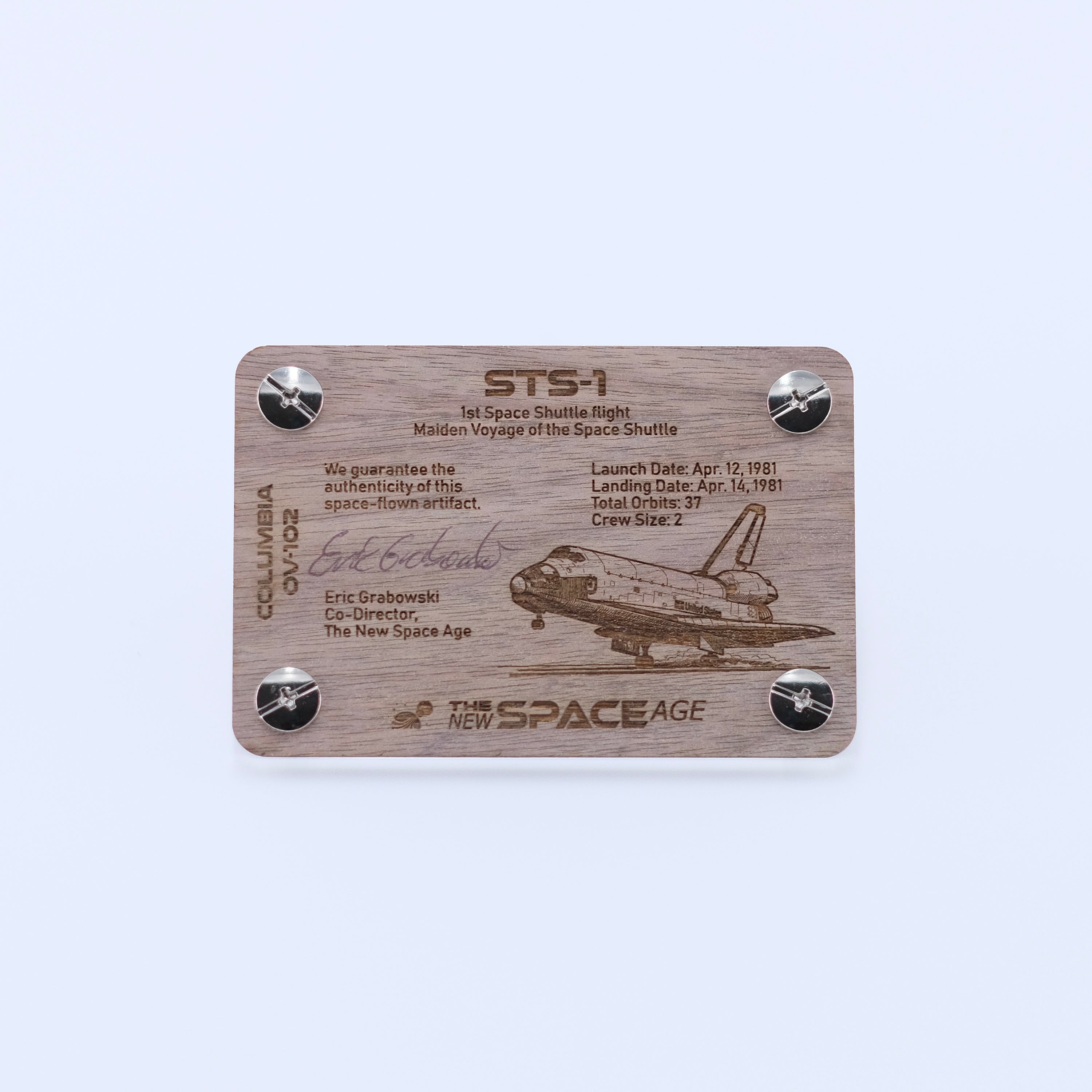 Back side of the STS-1 Columbia flown panel fragment artifact display card featuring mission details, authenticity statement, and Space Shuttle Columbia engraving.