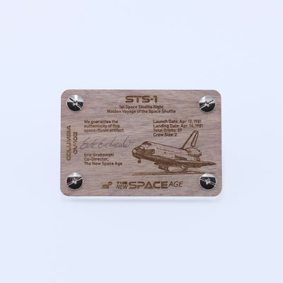 Back side of the STS-1 Columbia flown panel fragment artifact display card featuring mission details, authenticity statement, and Space Shuttle Columbia engraving.
