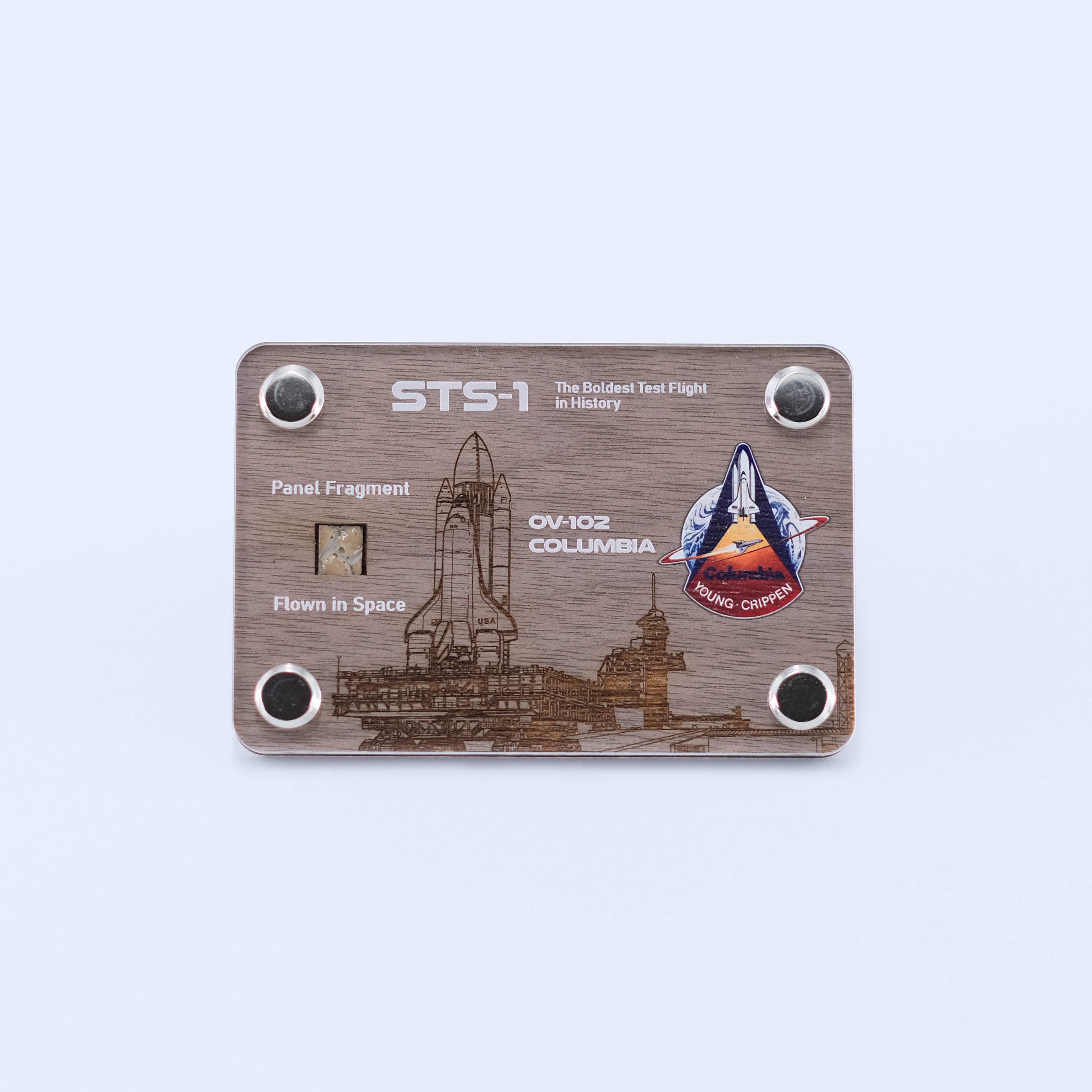 Authentic flown panel fragment from Space Shuttle Columbia STS-1, the first Space Shuttle mission, displayed in a handcrafted collectible artifact card.