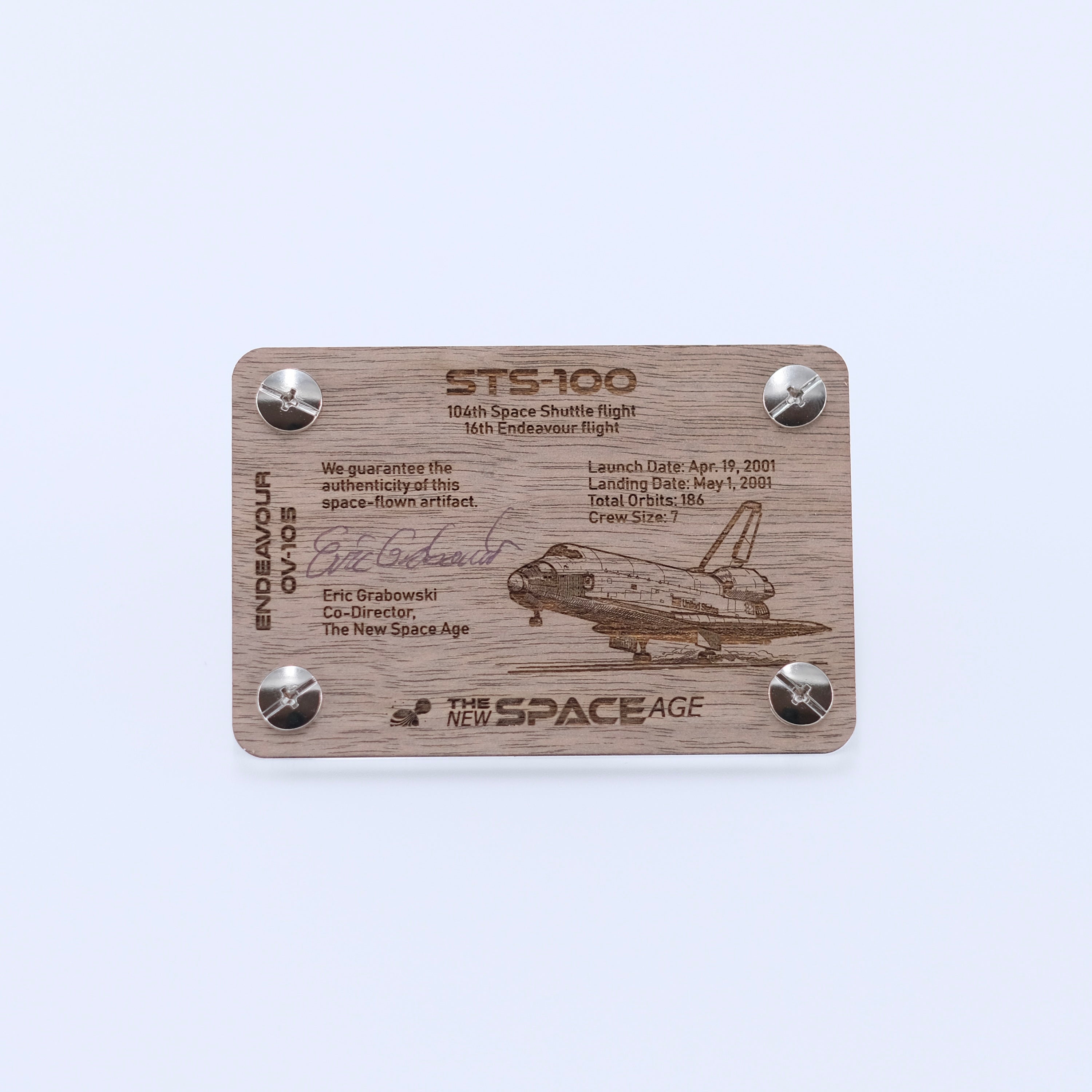 Back side of the STS-100 Endeavour flown payload bay liner artifact display card featuring mission details, authenticity statement, and Space Shuttle Endeavour engraving.