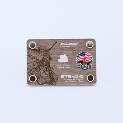 Authentic flown AFRSI thermal blanket artifact from Space Shuttle Challenger STS-41-G, the mission featuring the first spacewalk by a U.S. woman and the first Canadian in space, displayed in a handcrafted collectible card.