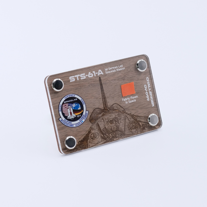 Angled view of an authentic flown space fabric artifact display card from Space Shuttle Challenger STS-61A, the first German-led Spacelab mission.