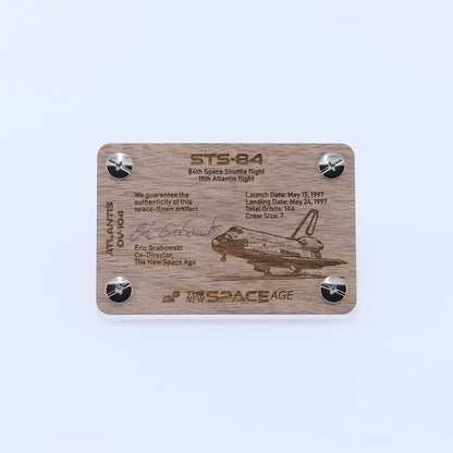 Back side of the STS-84 Atlantis flown gap filler artifact display card featuring mission details, authenticity statement, and Space Shuttle Atlantis engraving.
