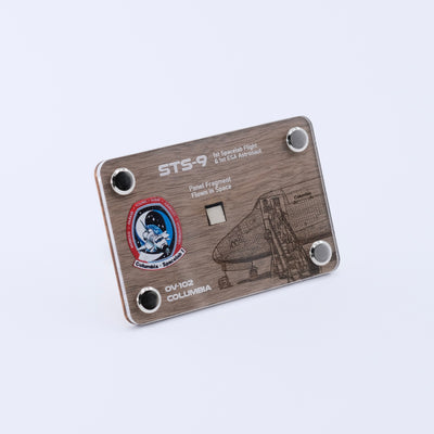 Angled view of the STS-9 Columbia display card with a flown panel fragment from the first Spacelab mission