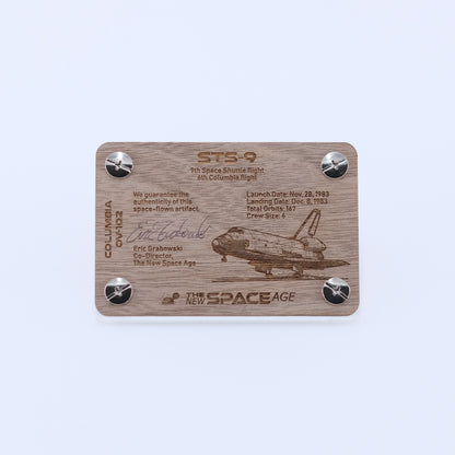 Back side of the STS-9 Columbia flown panel fragment artifact display card featuring mission details, authenticity statement, and Space Shuttle Columbia engraving.