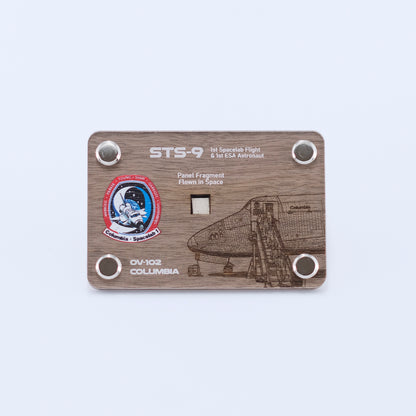 Authentic flown panel fragment from Space Shuttle Columbia STS-9, the first Spacelab mission and first flight of an ESA astronaut, displayed in a handcrafted artifact card.