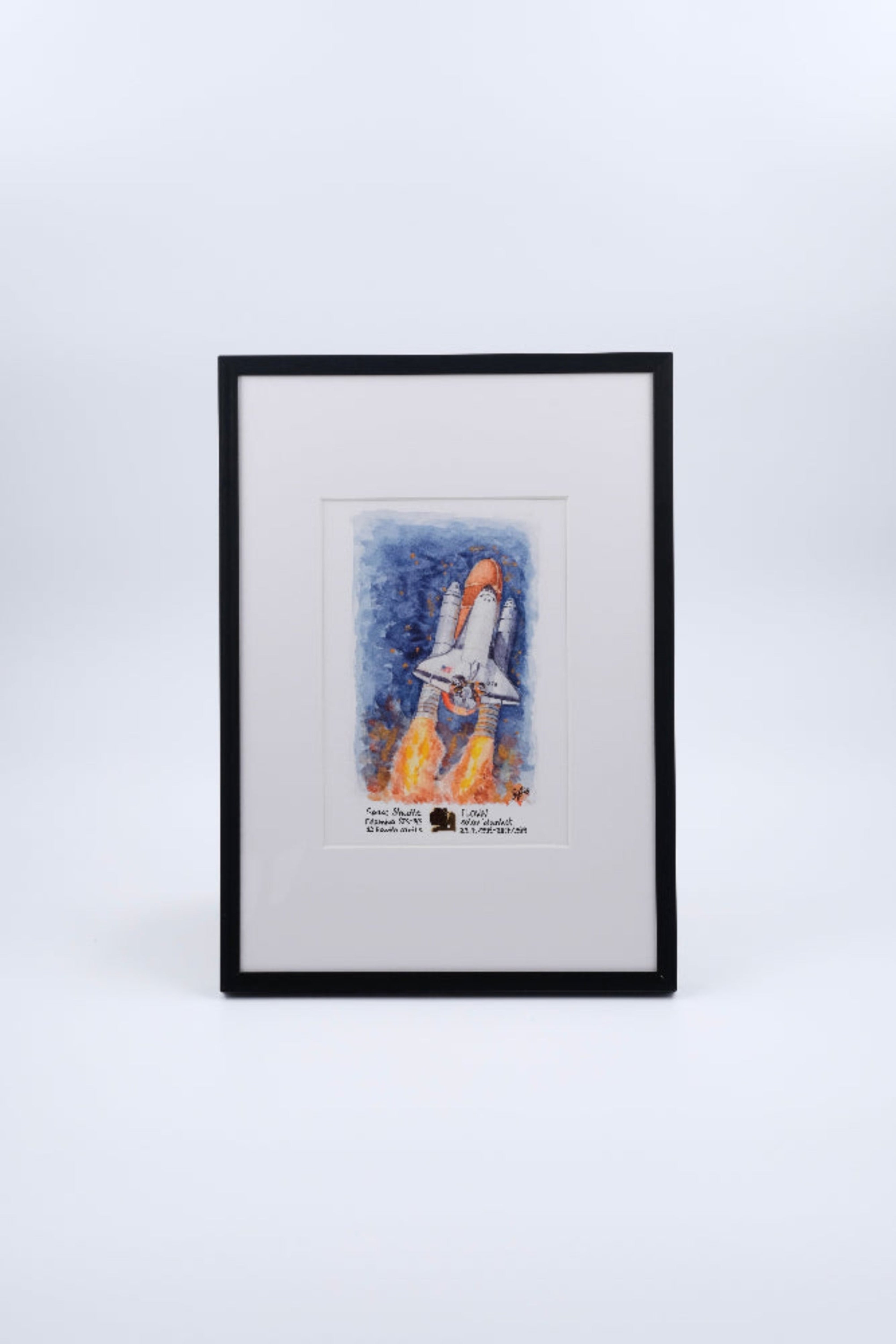 Framed watercolor artwork of a Space Shuttle launch with rocket plumes, presented as fine art print by The New Space Age. Combined with a flown solar blanket piece of Space Shuttle Columbia.