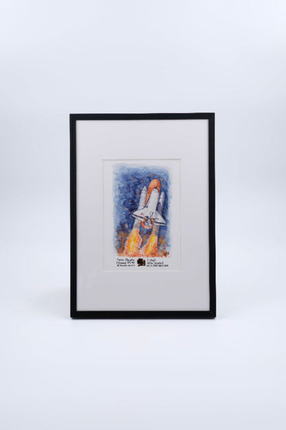Framed watercolor artwork of a Space Shuttle launch with rocket plumes, presented as fine art print by The New Space Age. Combined with a flown solar blanket piece of Space Shuttle Columbia.