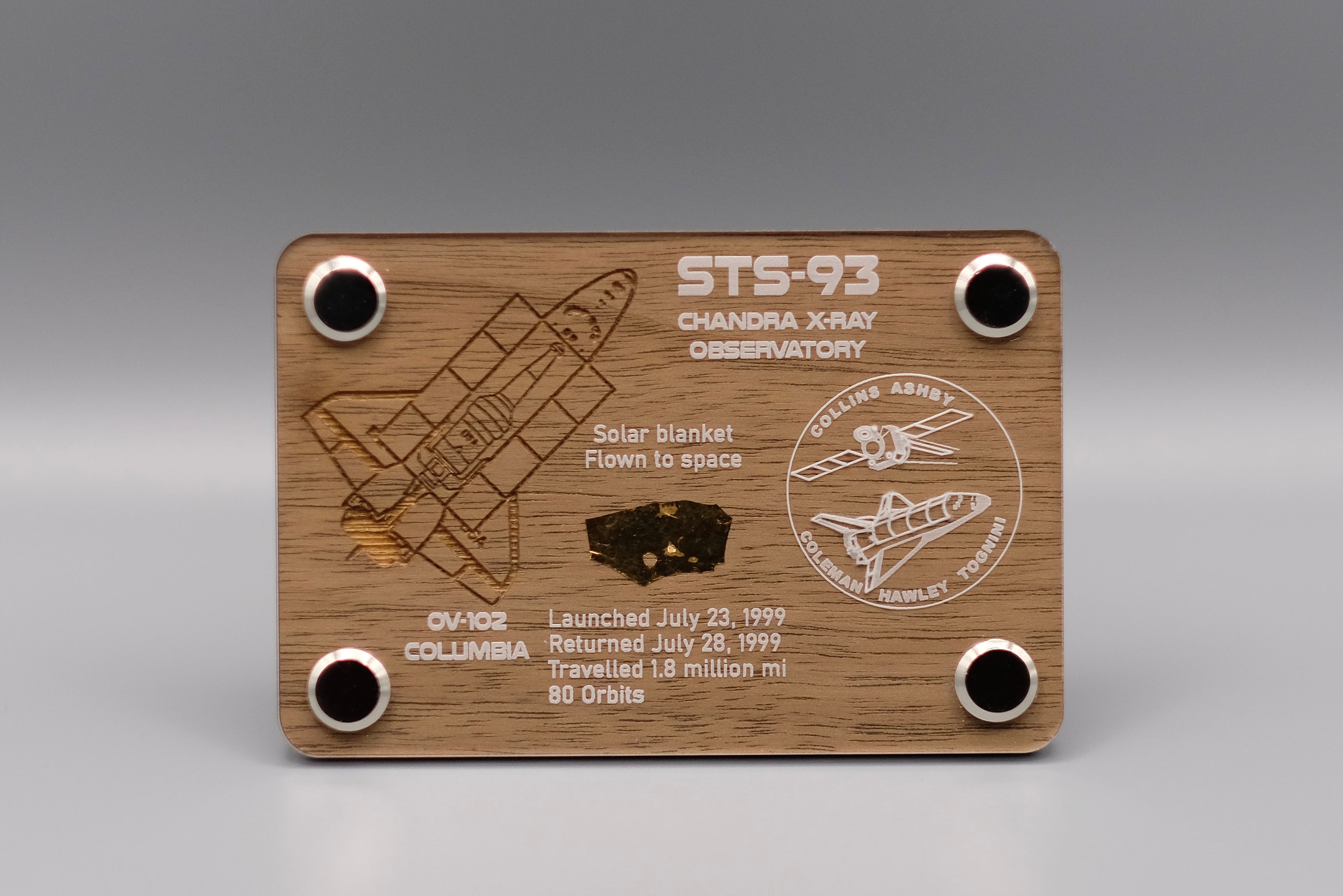 Premium wooden display with flown solar blanket fragment from Space Shuttle Columbia STS-93 mission, featuring engraved mission details and Chandra X-ray Observatory emblem.