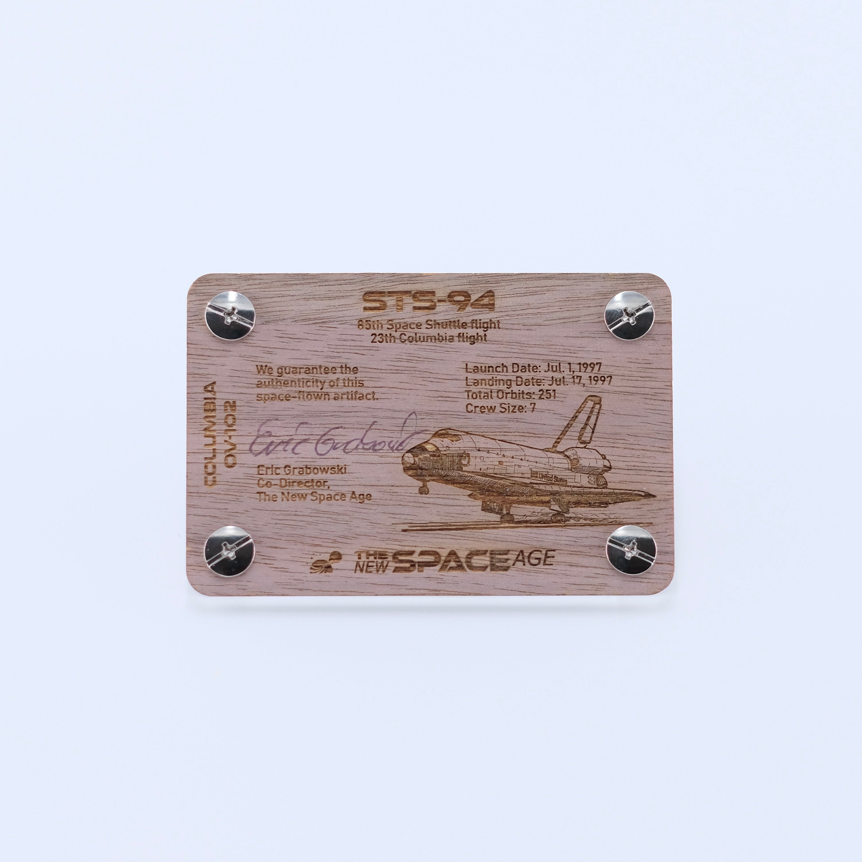 Back side of the STS-94 Columbia flown thermal blanket artifact display card featuring mission details, authenticity statement, and Space Shuttle Columbia engraving.
