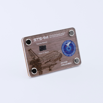 Authentic flown thermal blanket artifact from Space Shuttle Columbia STS-94, the reflight of the Microgravity Science Laboratory mission, displayed in a handcrafted collectible card.