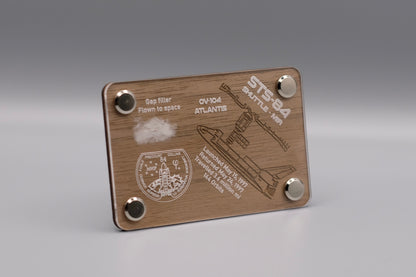 Space Shuttle Atlantis STS-84 display side view featuring a flown gap filler from the 1997 Shuttle-Mir mission – authentic space-flown artifact mounted on engraved wood plaque, available at The New Space Age Store.
