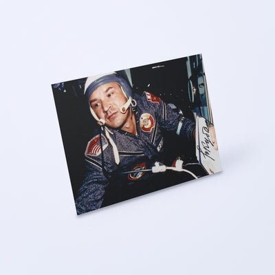 Signed photo of cosmonaut Valery Kubasov from the Apollo-Soyuz mission, shown at an angle on a light background