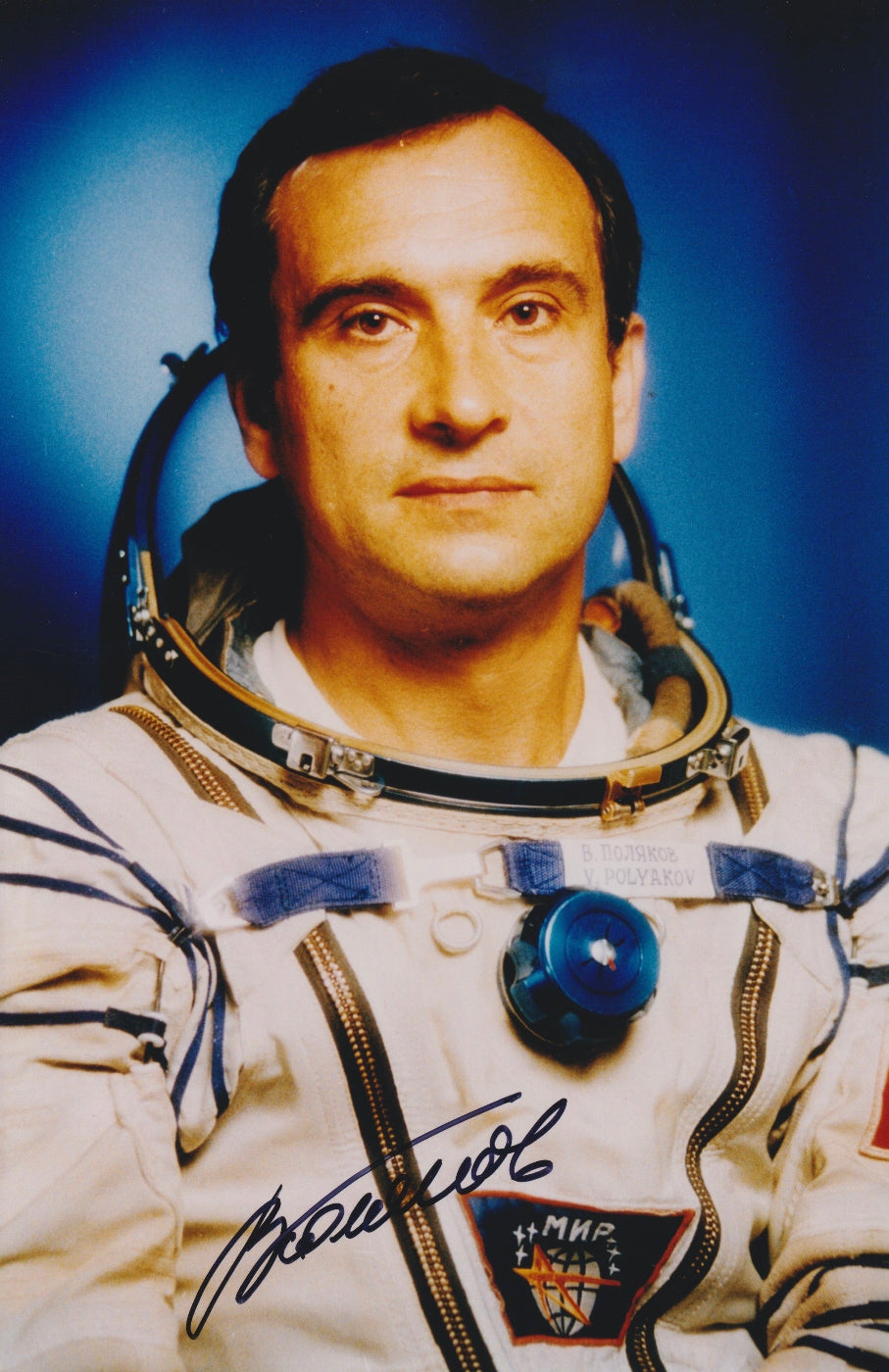 Signed portrait of cosmonaut Valery Polyakov in Sokol spacesuit with MIR mission patch, perfect for space memorabilia collectors