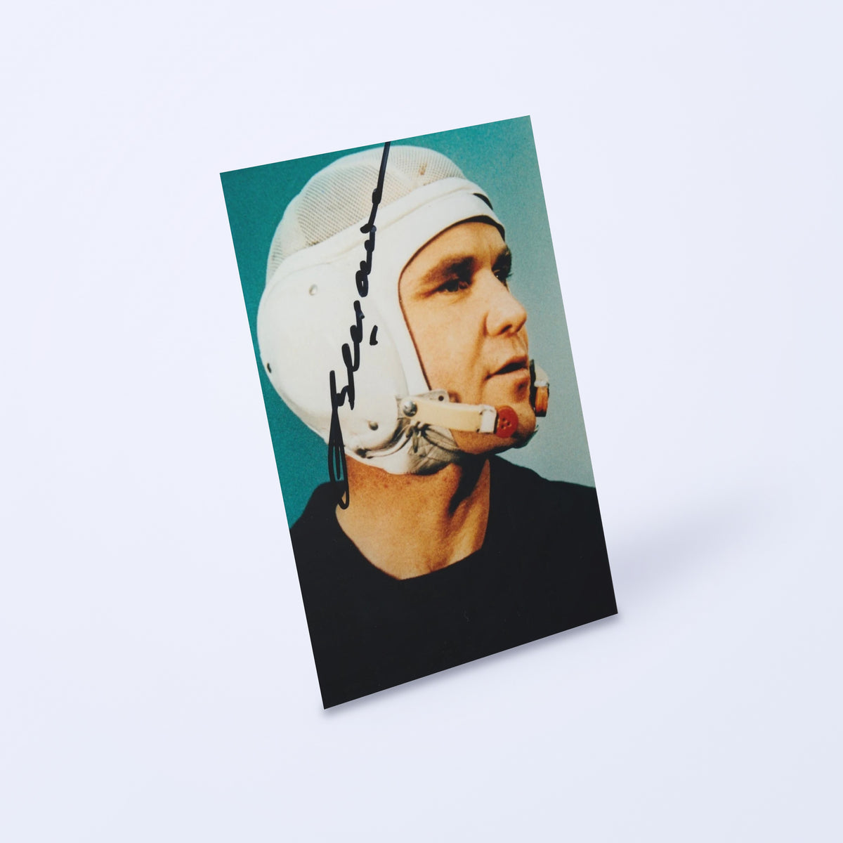 Signed portrait of cosmonaut Vladimir Shatalov in a white communications cap, shown at an angle on a light background