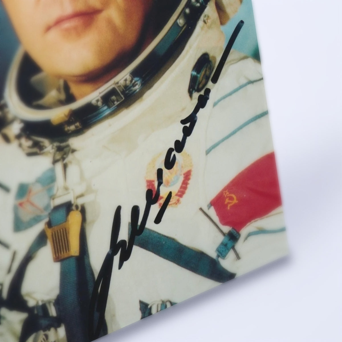 Close-up of Vladimir Shatalov's signature on the Sokol spacesuit portrait