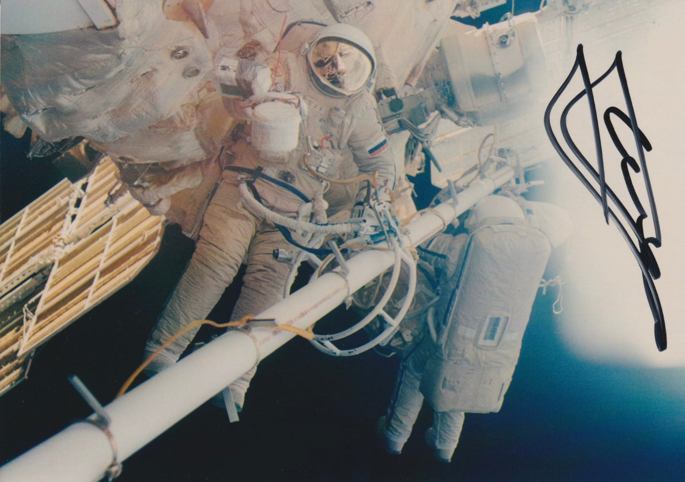 Signed portrait of cosmonaut Yuri Gidzenko in Orlan EVA spacesuit during spacewalk, ideal for space memorabilia collectors
